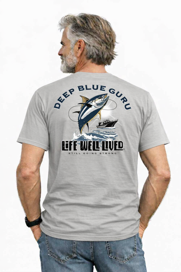 Man wearing a gray t-shirt with 'Deep Blue Guru' and fishing graphic on the back.