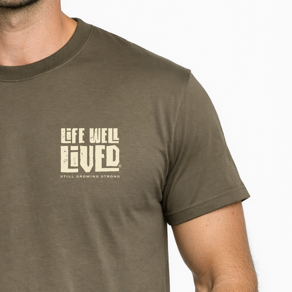 Man wearing a brown t-shirt with 'Life Well Lived' text on a white background