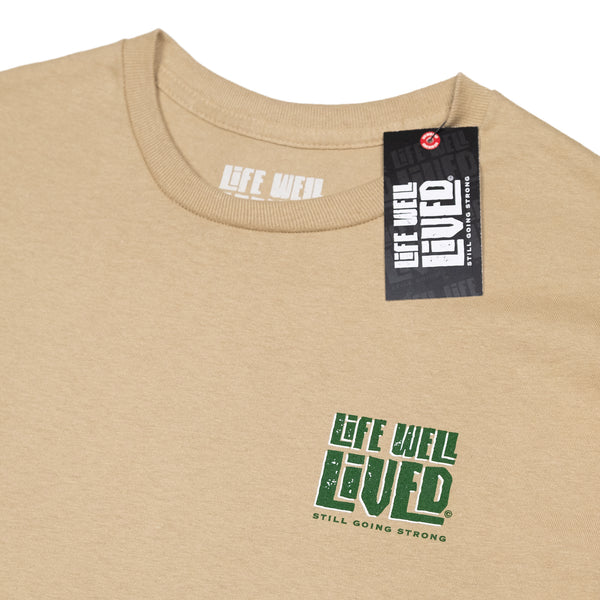 This mens graphic back print Tee shirt, shows an image of a beer pump being pulled, next to the pump is a traditional pint glass full of beer, the beer being pulled is called 'Hoppy Daze'  The strapline above says hops & Dreams, a great t shirt for any beer lover, finished in golden graphics with green lettering on a Tan colour base Tee.