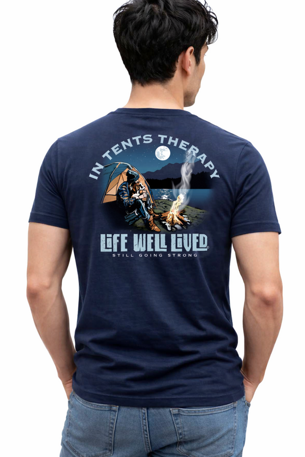 Man wearing a navy blue t-shirt with graphic design and text on the back, standing against a white background.