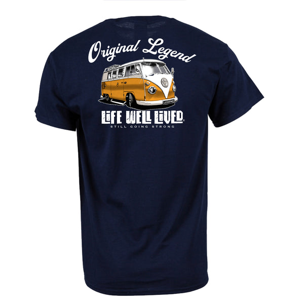 Back view of navy Original Legend T‑shirt featuring orange and white classic camper van graphic with Original Legend text above and Life Well Lived Still Going Strong branding below.