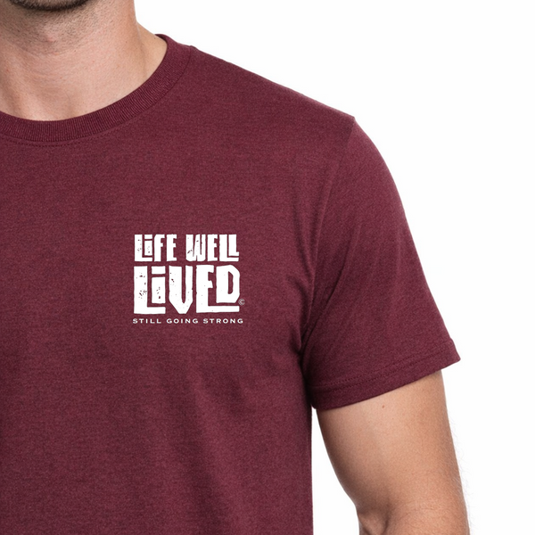 Maroon t-shirt with 'Life Well Lived' text on a white background