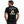 A man shown from the back wearing a black graphic t-shirt. The shirt features a large back print with the text 'WELL BREWED Full of Character' and 'LEFT WELL LIVED THE BREWING WAY' surrounding an illustration of a beer bottle, a beer mug, and hops.
