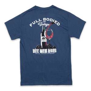 Classic mens back print graphic Tee, depicting a red wine bottle next to a glass of wine being poured, Above the image it reads 'Full Bodied Vintage in white lettering. The Tee is on a blue Dusk colour. Underneath the image it reads 'Life Well Lived, 'still going strong'.