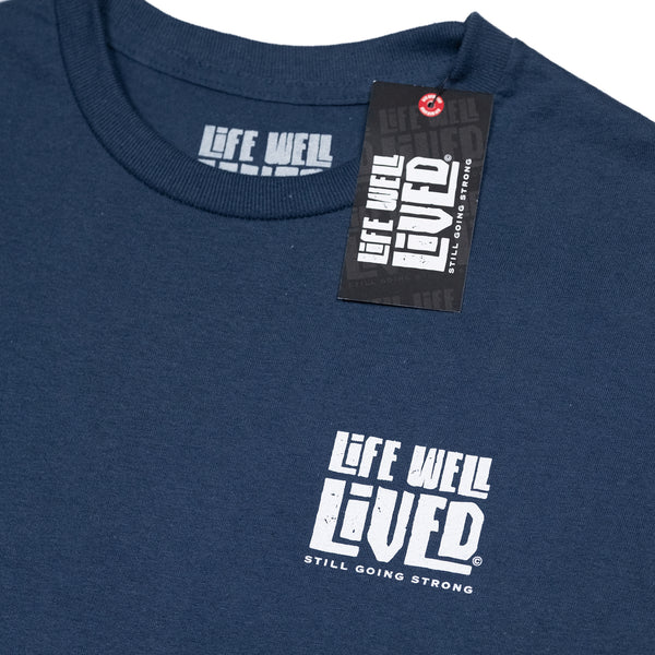 Classic mens back print graphic Tee, depicting a red wine bottle next to a glass of wine being poured, Above the image it reads 'Full Bodied Vintage in white lettering. The Tee is on a blue Dusk colour. Underneath the image it reads 'Life Well Lived, 'still going strong'.