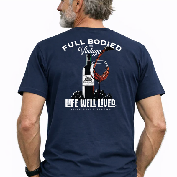 Man wearing a navy blue t-shirt with a graphic design on the back, featuring text and an illustration of a wine bottle and glass.