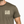 Man wearing a brown t-shirt with 'Life Well Lived' text on a white background
