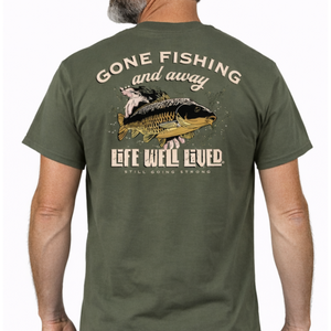 Back view of olive green Gone Fishing T‑shirt featuring large carp being released into the water with Gone Fishing and Away text above and Life Well Lived Still Going Strong branding below.