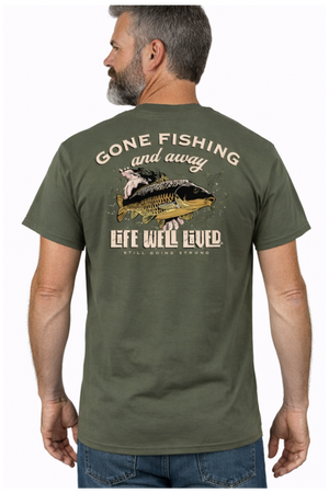 Back view of olive green Gone Fishing T‑shirt featuring large carp being released into the water with Gone Fishing and Away text above and Life Well Lived Still Going Strong branding below.