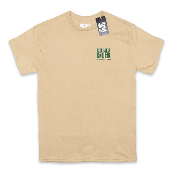 This mens graphic back print Tee shirt, shows an image of a beer pump being pulled, next to the pump is a traditional pint glass full of beer, the beer being pulled is called 'Hoppy Daze'  The strapline above says hops & Dreams, a great t shirt for any beer lover, finished in golden graphics with green lettering on a Tan colour base Tee.