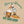 This mens graphic back print Tee shirt, shows an image of a beer pump being pulled, next to the pump is a traditional pint glass full of beer, the beer being pulled is called 'Hoppy Daze'  The strapline above says hops & Dreams, a great t shirt for any beer lover, finished in golden graphics with green lettering on a Tan colour base Tee.
