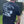 Black Well Oiled Half Cut T‑Shirt with bold lawnmower back print worn outdoors.