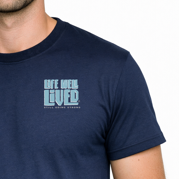Navy blue t-shirt with 'Life Well Lived' text worn by a person on a white background