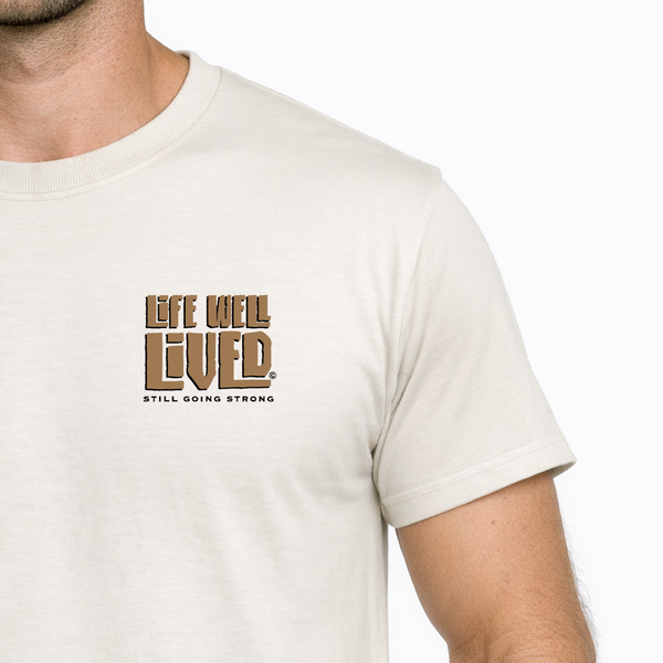 Man wearing a white t-shirt with 'Life Well Lived' text on a plain background