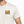 Man wearing a white t-shirt with 'Life Well Lived' logo on a plain background