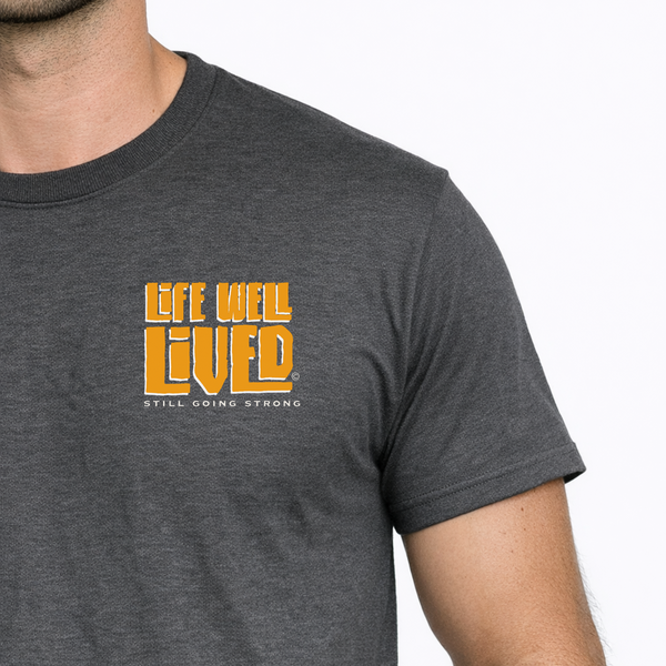 Man wearing a dark gray t-shirt with 'Life Well Lived' text in orange on a white background