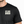 Front chest view of the Well Oiled Half Cut black T‑Shirt worn by a male model, showing the life Well Lived Logo.