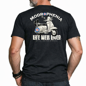 Man wearing a black t-shirt with a graphic design and text on the back, standing against a white background.