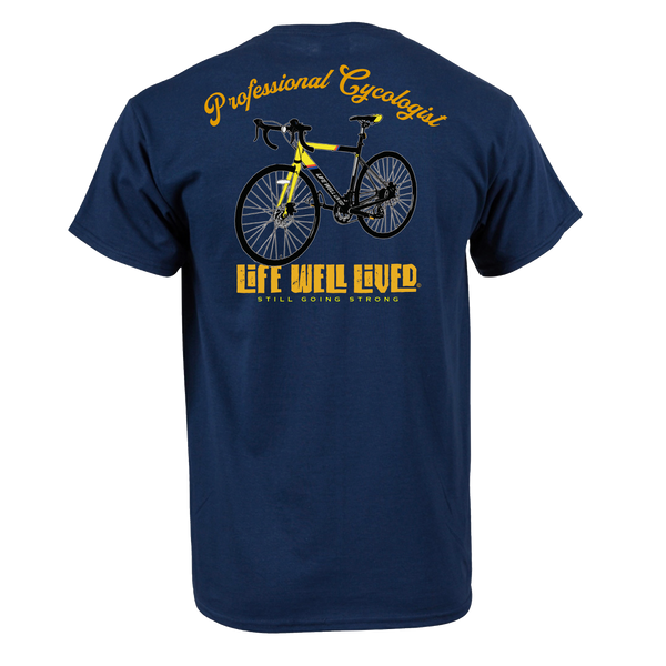 Back view of navy Professional Cyclologist cycling T‑shirt featuring yellow road bike graphic with Professional Cyclologist text above and Life Well Lived Still Going Strong branding below.