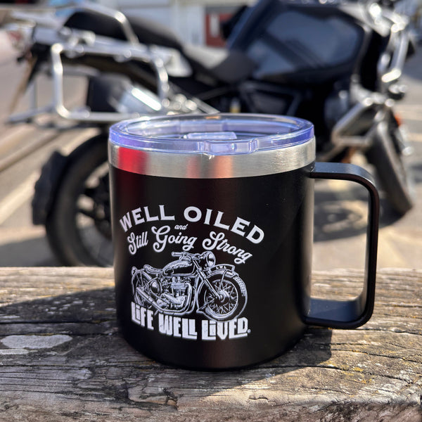 Life Well Lived Well Oiled 14oz black thermal mug with a vintage motorcycle design on an insulated travel mug.