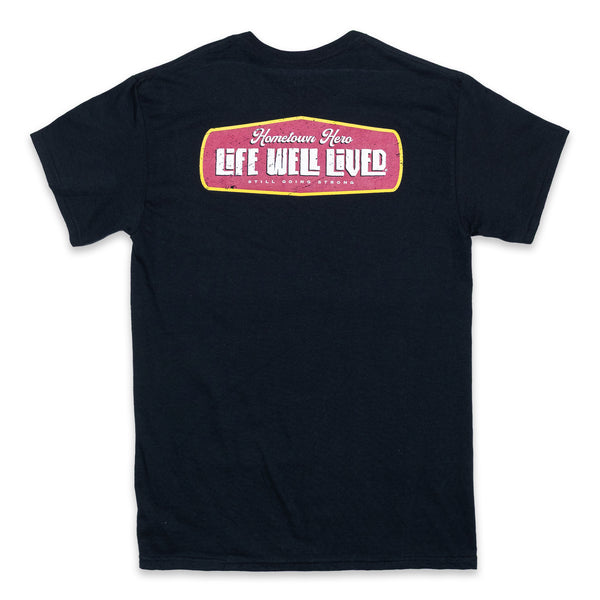 Mens graphic Tee in Black, red and yellow image on shoulders saying 'Life Well Lived Hometown hero'.