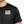 Black t-shirt with 'Life Well Lived' text worn by a person on a white background