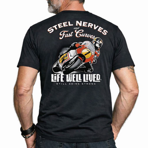 Back view of a male model wearing the dark grey Steel Nerves Super Bike T‑Shirt featuring the motorcycle racer graphic with Steel Nerves and Life Well Lived text.