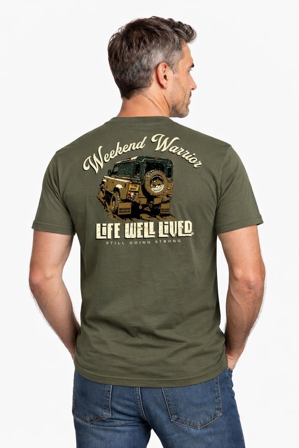 Man wearing a green t-shirt with 'Weekend Warrior' and 'Life Well Lived' text and graphic on the back.