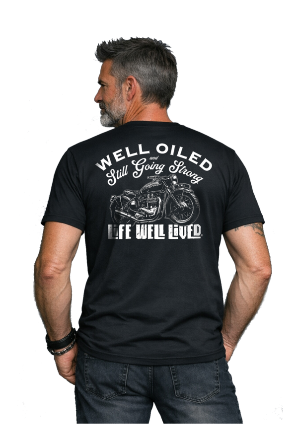 Man wearing a black t-shirt with a motorcycle graphic and text on the back, on a white background