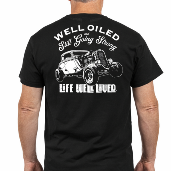 Man wearing a black t-shirt with a graphic and text on the back, standing against a white background.